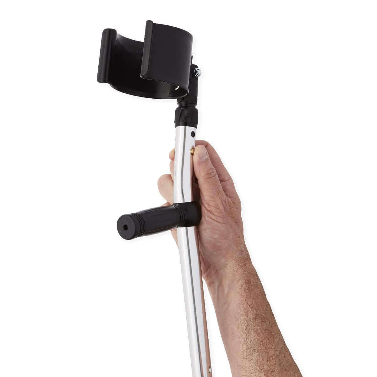 Forearm crutch with black open cuff and hand grip held by a person's hand, showing silver aluminum adjustable shaft