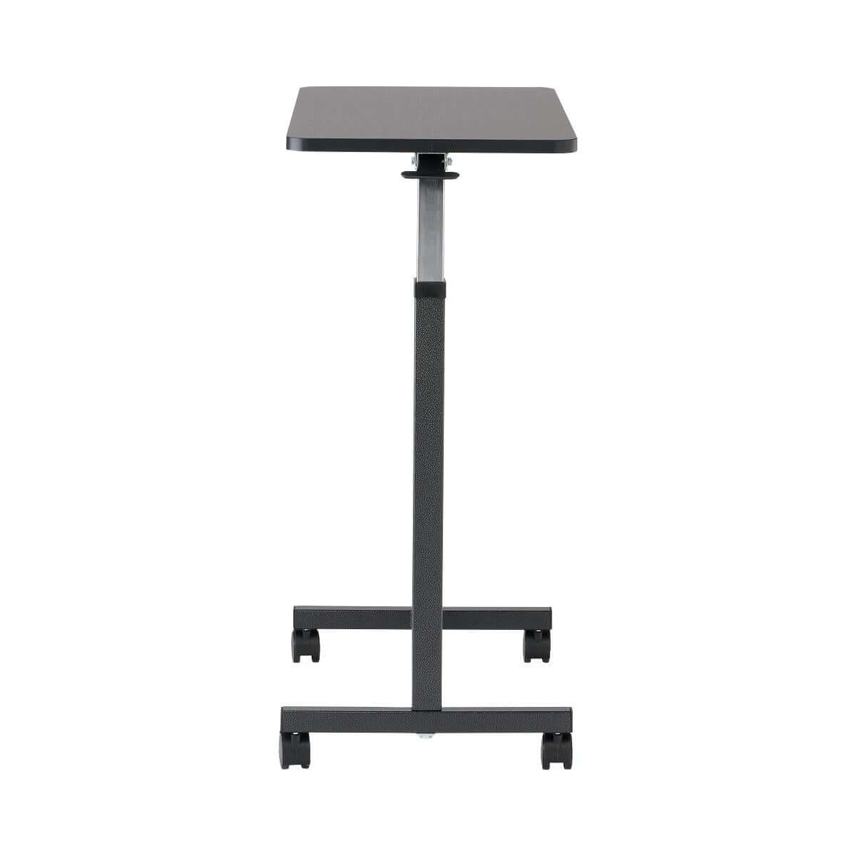 Overbed table with dark rectangular surface, adjustable black metal post, cross base, and four locking casters