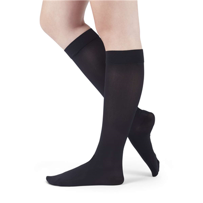 Compression knee-high socks in black, worn on both legs, shown from the knees down against a white background