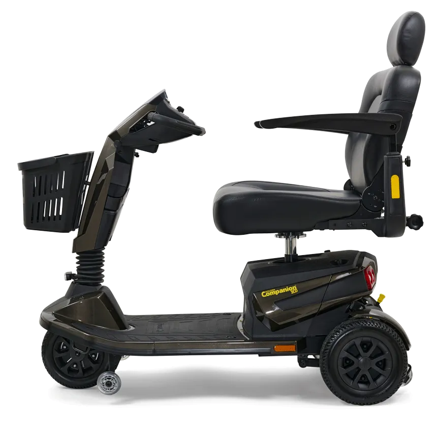 Power mobility scooter in dark gray with high-back padded seat, armrests, front basket, and three wheels, shown from the side