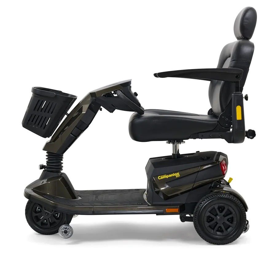 Power mobility scooter in dark gray with padded captain's seat, armrests, headrest, front basket, and four wheels, shown