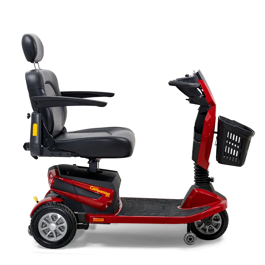 Mobility scooter in red with black padded seat, headrest, armrests, tiller controls, and front basket, shown from the side