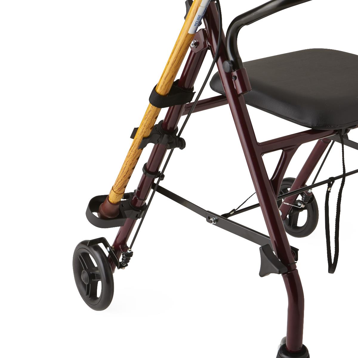 Rollator walker cane holder attachment securing a wooden cane to a burgundy rollator frame with strap clips