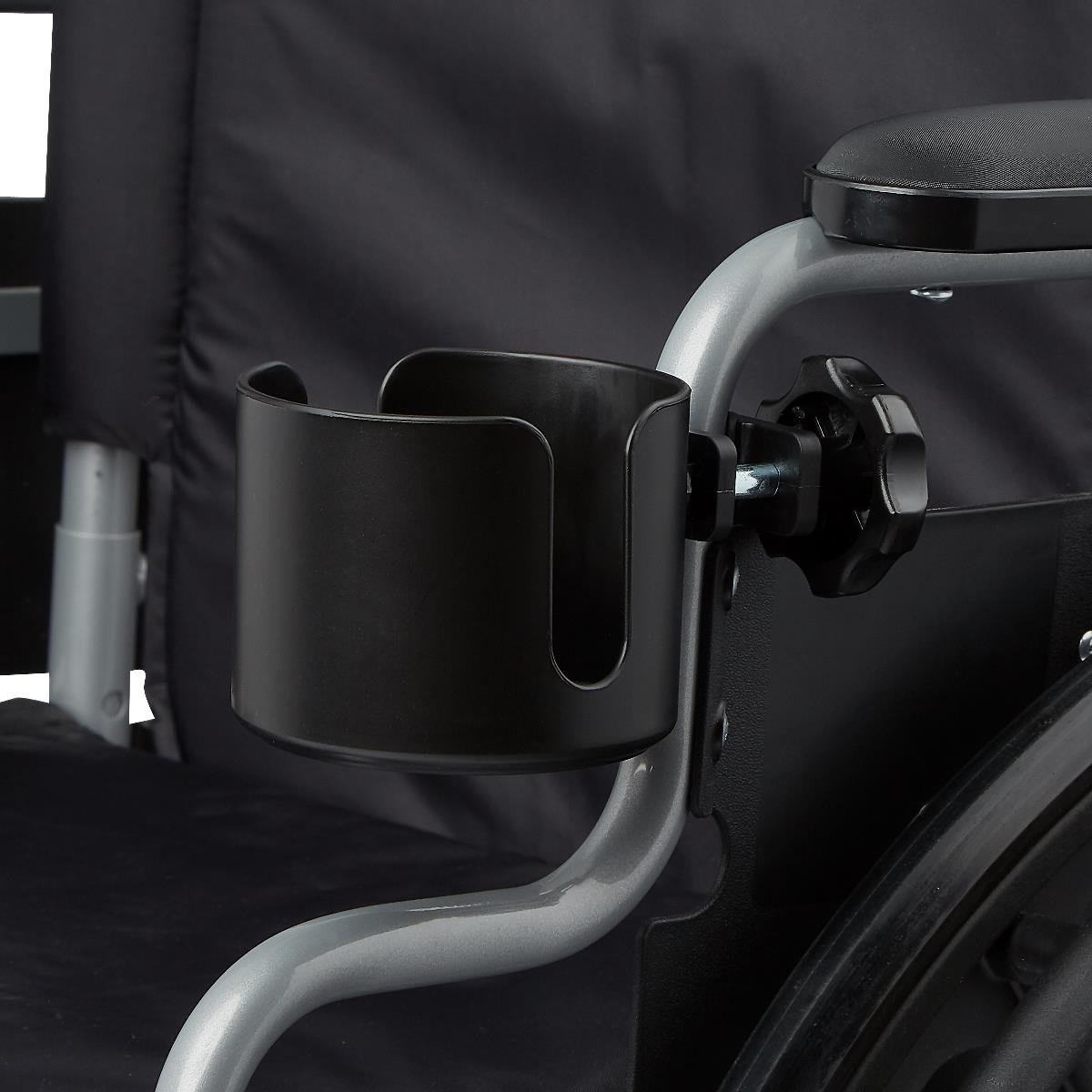 Cup holder with clamp mount attached to a wheelchair armrest frame, shown in black plastic with a knob fastener