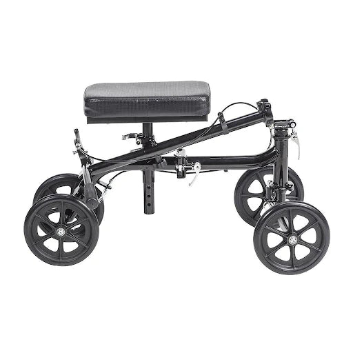 Knee walker with black frame, padded knee rest, four large spoke wheels, and handlebar-mounted hand brakes, shown from the