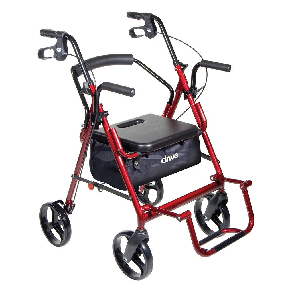 Duet transport rollator walker with red frame, padded seat, hand brakes, armrests, footrests, and black storage bag on four