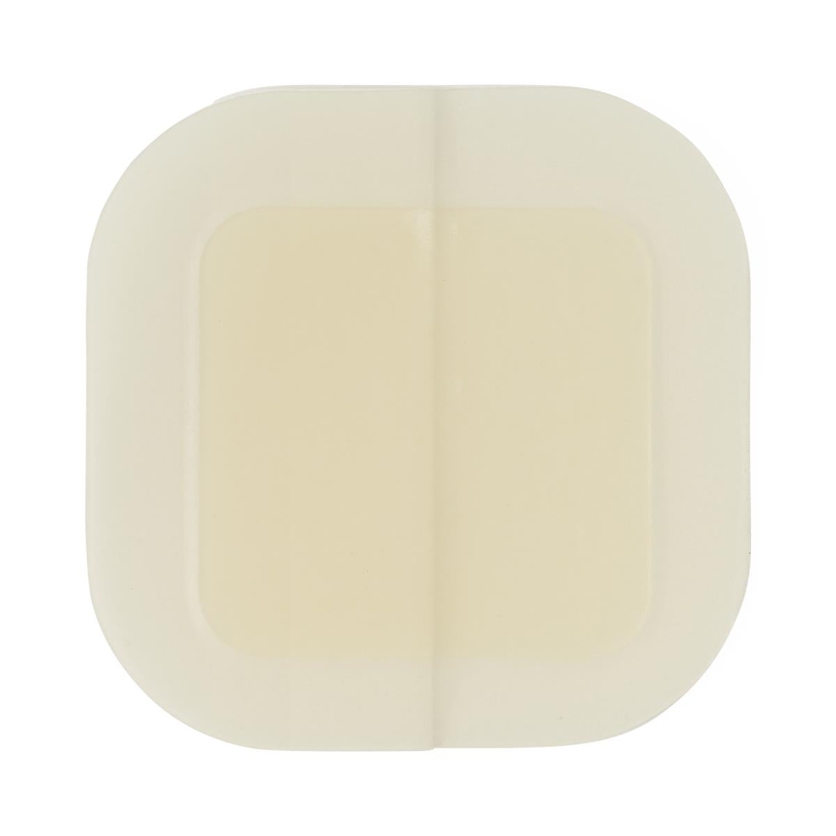 Foam wound dressing with raised absorbent center pad and rounded square shape, cream-colored, shown on white background