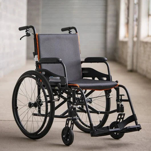 Lightweight wheelchair with black frame, gray mesh seat and back, orange trim accents, large rear wheels, and swing-away