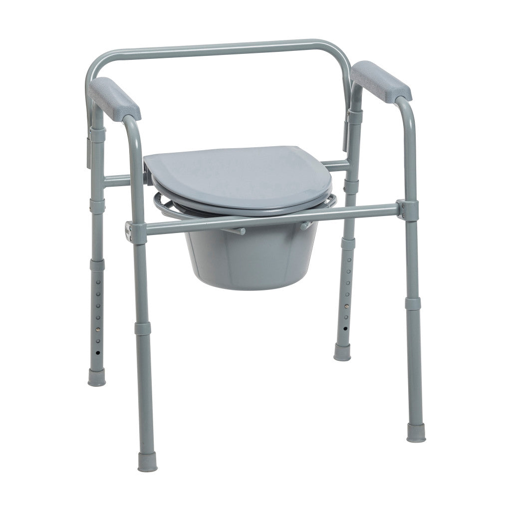 Folding bedside commode with gray steel frame, padded armrests, removable bucket, and lid on white background