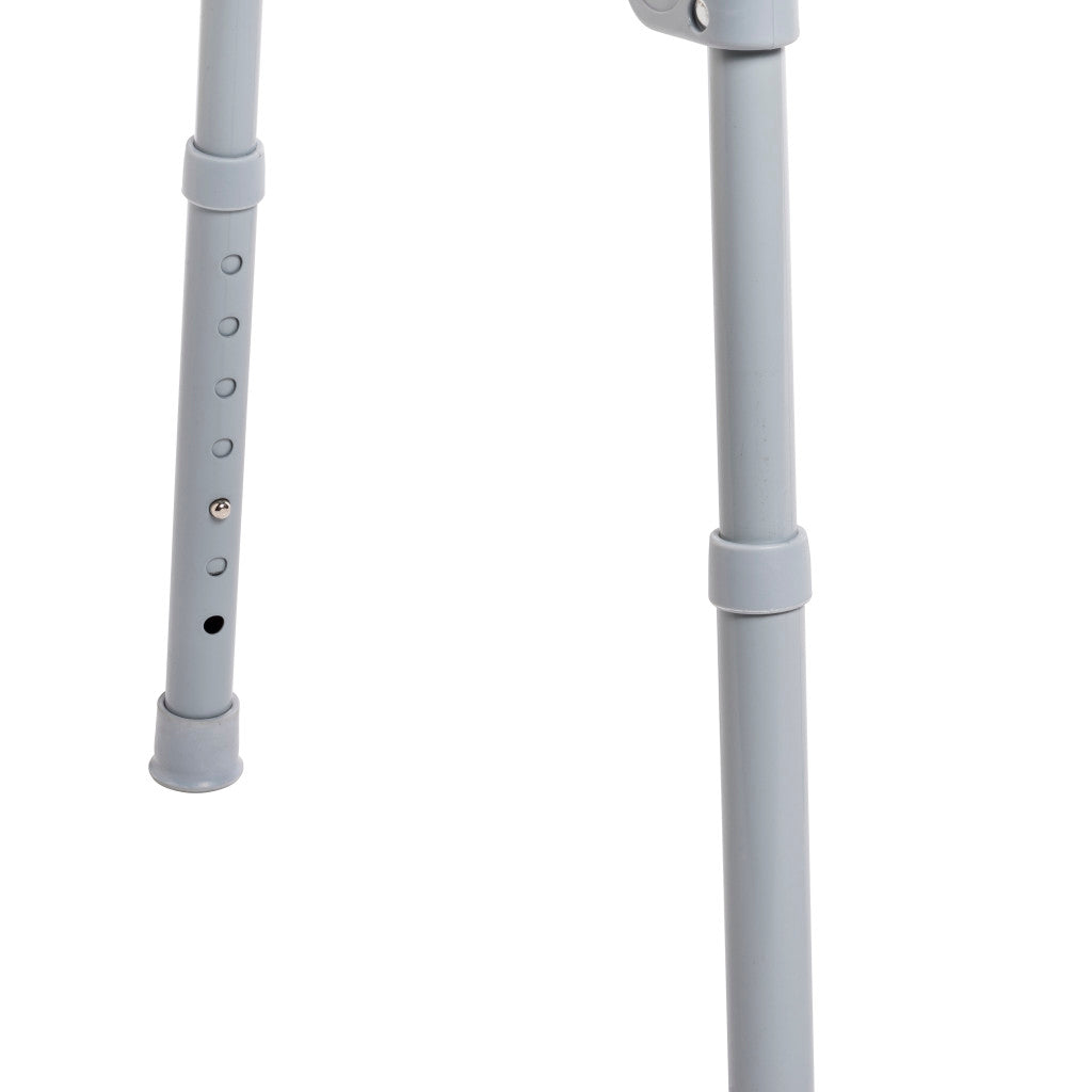 Folding bedside commode legs showing gray aluminum frame with height-adjustment holes, push-button pin, and rubber tips