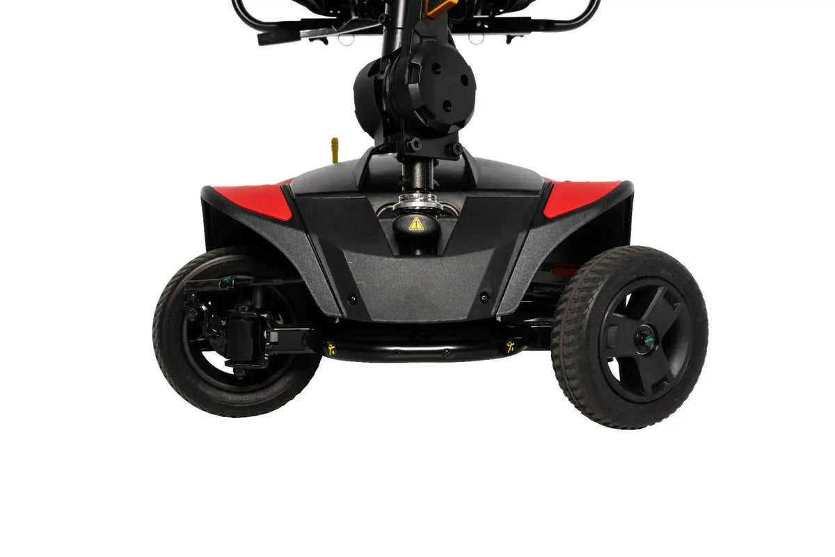 Power mobility scooter rear base and wheels, black and red housing with four-wheel design, front-facing close-up view