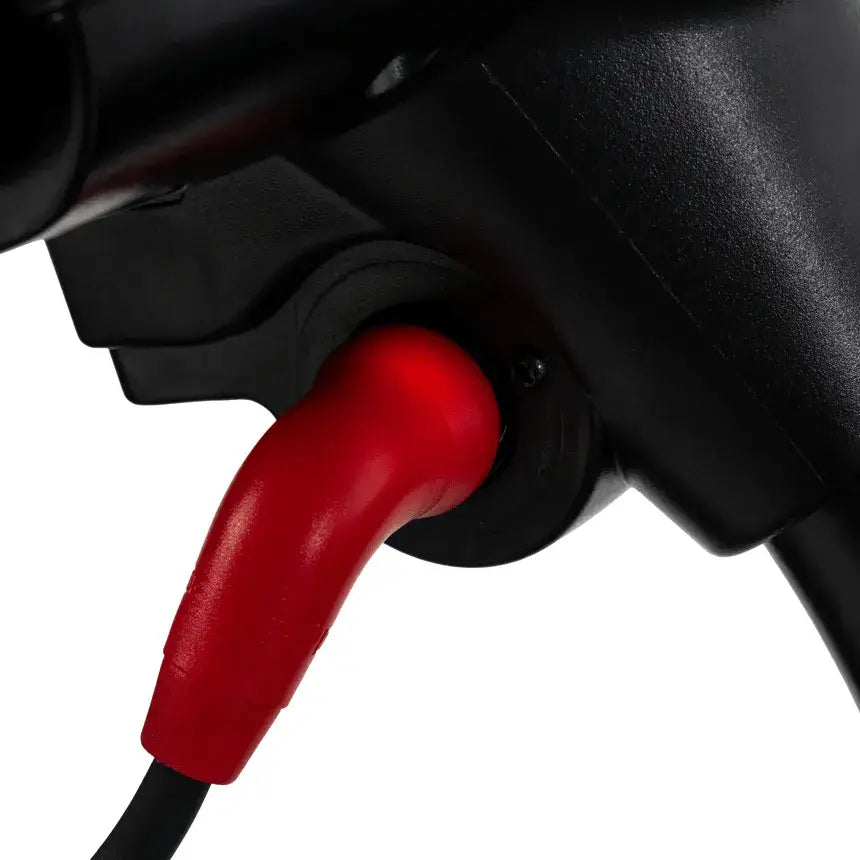 Power scooter tiller close-up showing red charging port connector and black plastic housing detail
