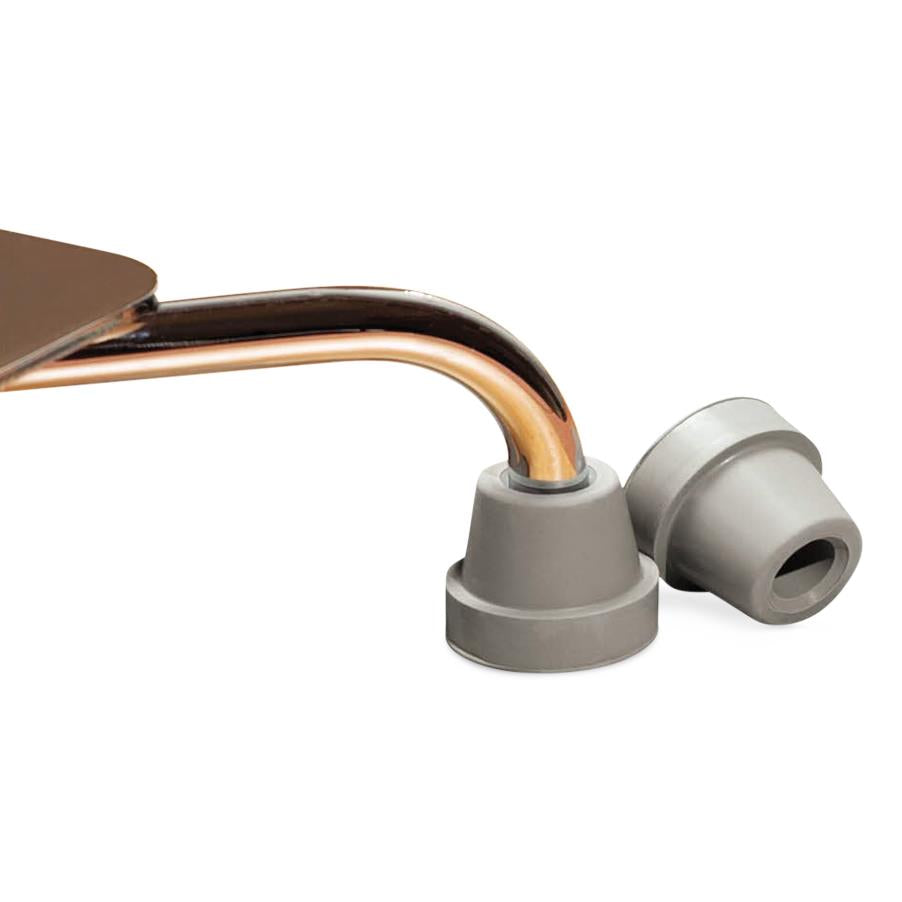 Quad cane tips in gray rubber shown fitted on a bronze-toned cane shaft, with one additional tip beside it