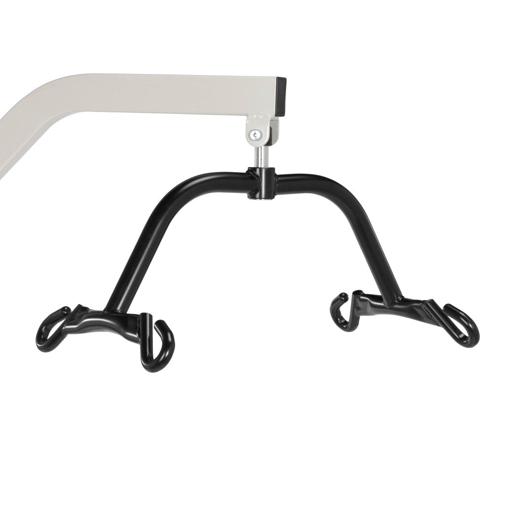 Patient lift four-point spreader bar in black steel with four hooks, attached to a white overhead lift arm