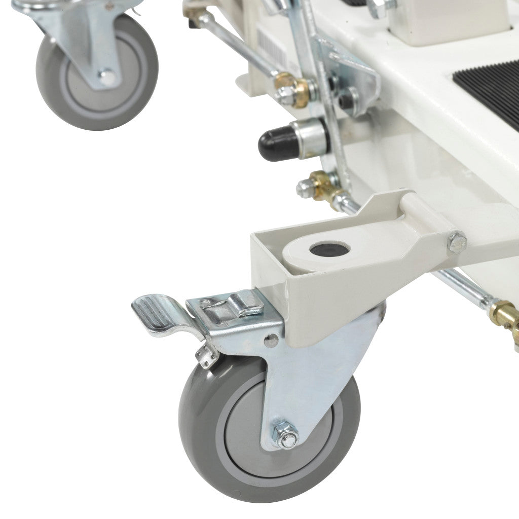 Bariatric electric patient lift base showing locking swivel casters, white metal frame, and brake mechanisms on a white