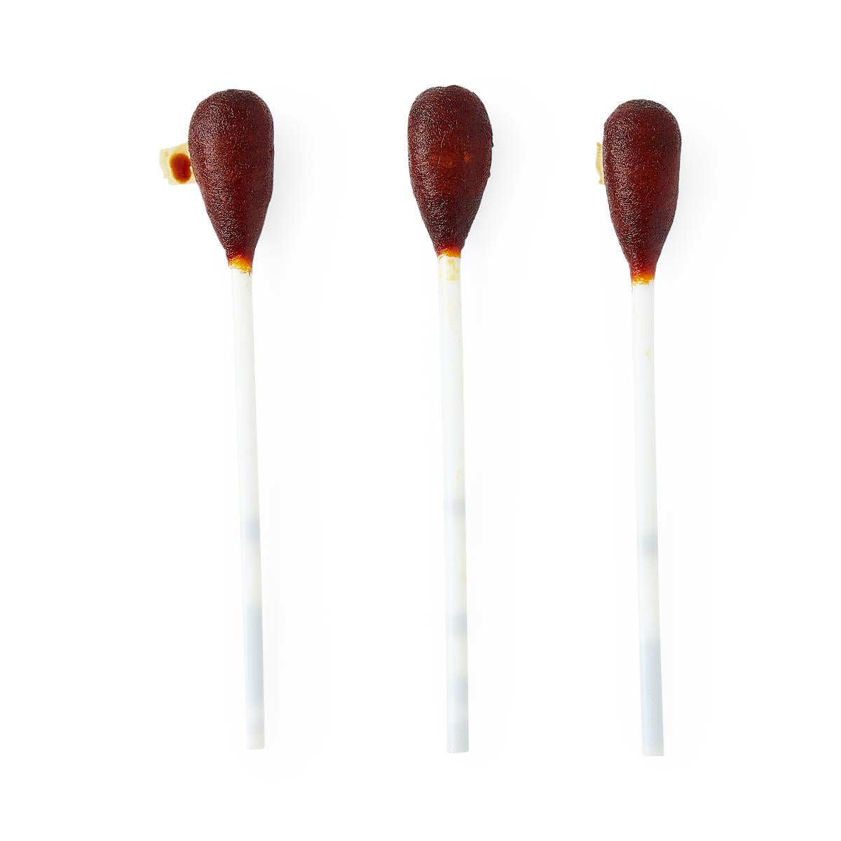 Povidone iodine swabsticks with dark brown saturated tips on white plastic handles, three shown on white background