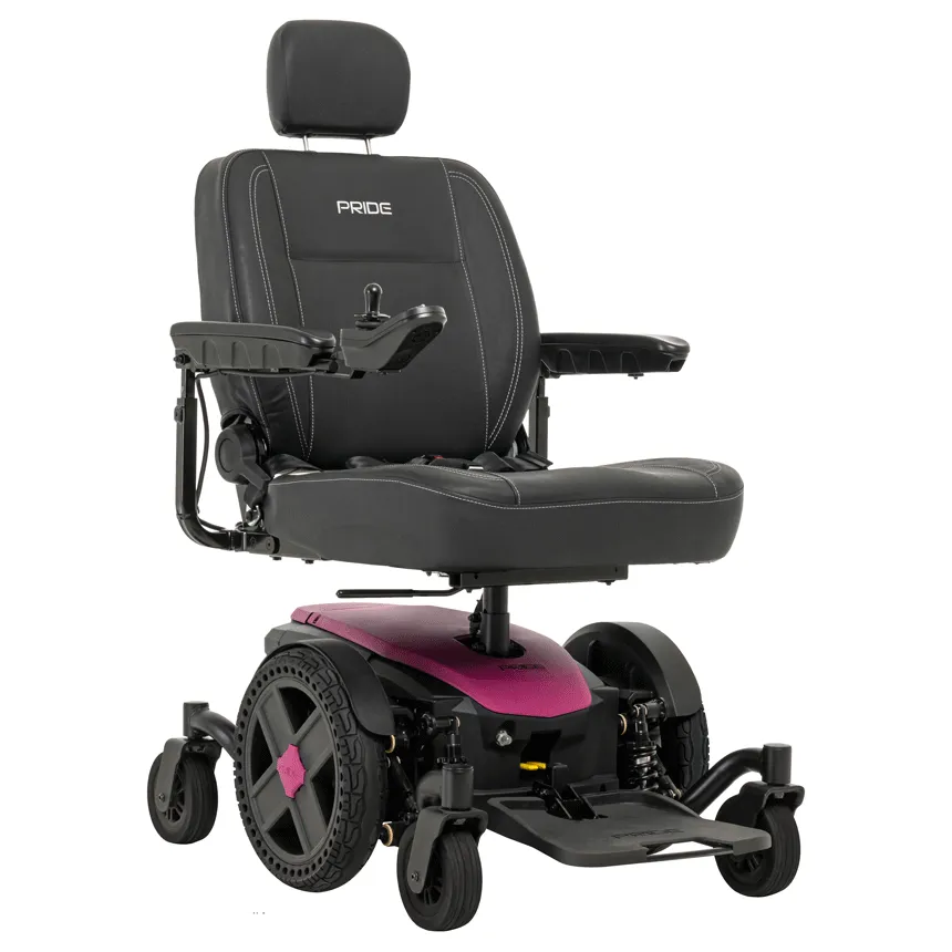 Power wheelchair with black upholstered seat, headrest, joystick controller, and pink mid-wheel drive base with six wheels