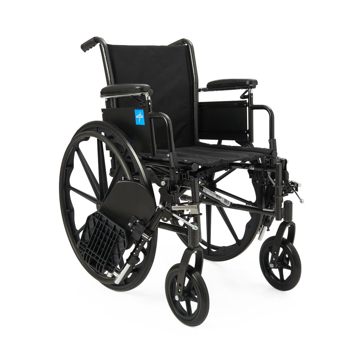 Wheelchair with black nylon upholstery, padded armrests, swing-away footrests, and large rear wheels on white background