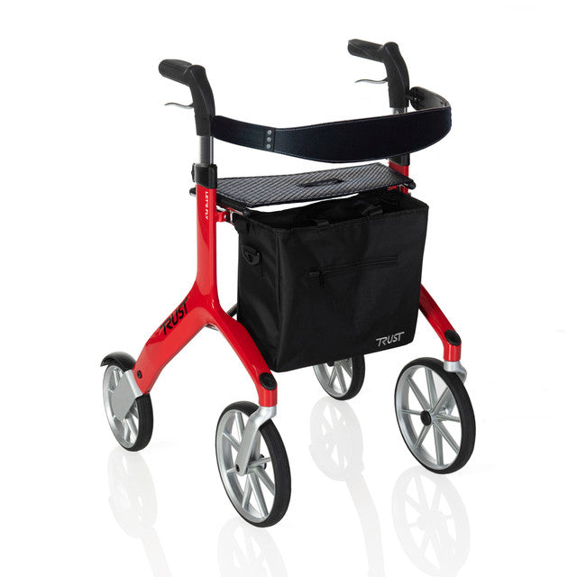 Four-wheel rollator in red with padded seat, loop hand brakes, black underseat bag, and large spoke wheels