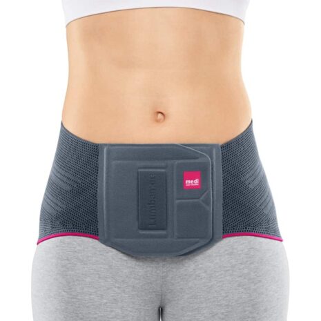 Lumbamed Plus lumbar support brace worn by a woman, gray knit fabric with structured back panel and pink trim accents