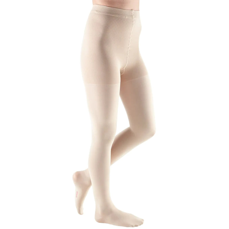 Compression pantyhose in beige with closed toe and adjustable waistband, shown on a model from the waist down