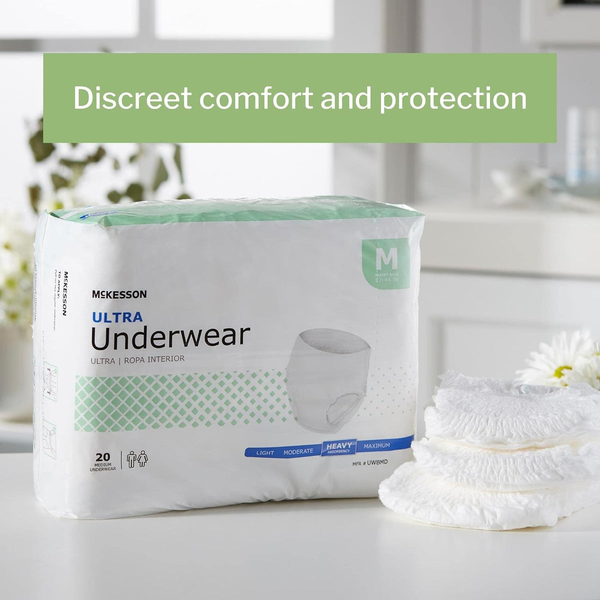 McKesson Ultra Pull On absorbent underwear package in medium size with stacked product samples beside it on a white