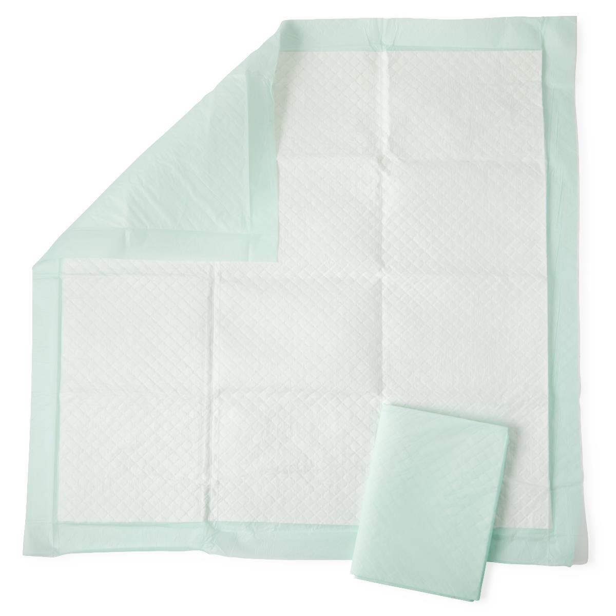 Disposable underpads with white quilted top surface and mint green backing, shown unfolded and folded on white background