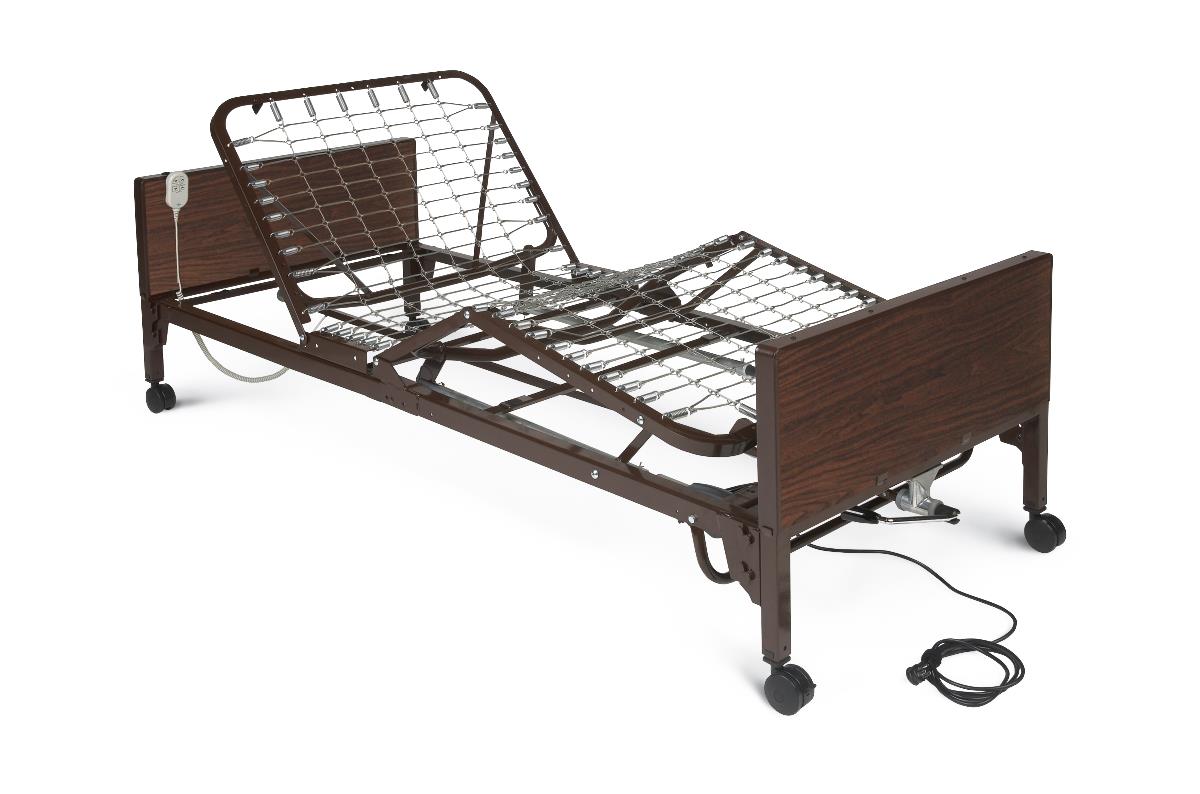 Electric hospital bed with raised head section, brown wood-grain side panels, metal spring frame, half rails, and hand