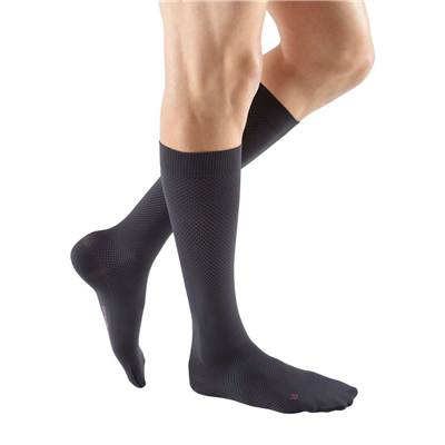 Compression socks in dark charcoal with subtle texture pattern, worn on male legs, knee-high closed toe style