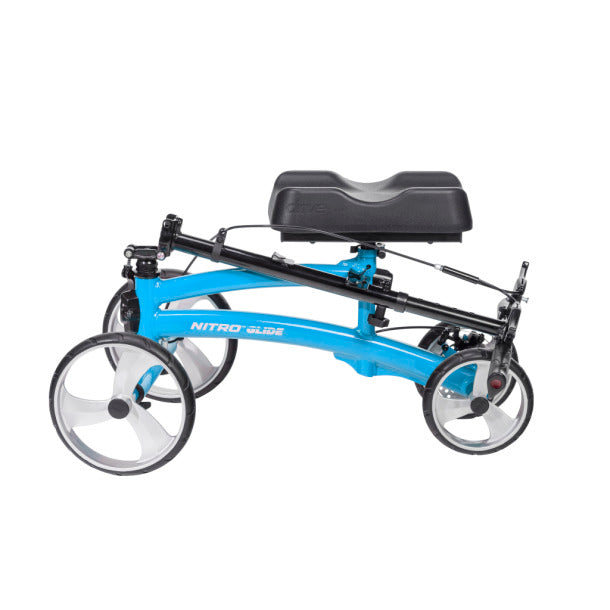 Knee walker with blue frame, padded knee rest, four wheels, and hand brakes, shown from the side on white background