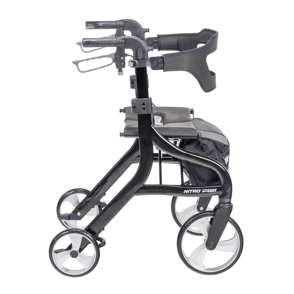 Rollator walker in black with four large wheels, padded seat, backrest, hand brakes, and under-seat bag, side view