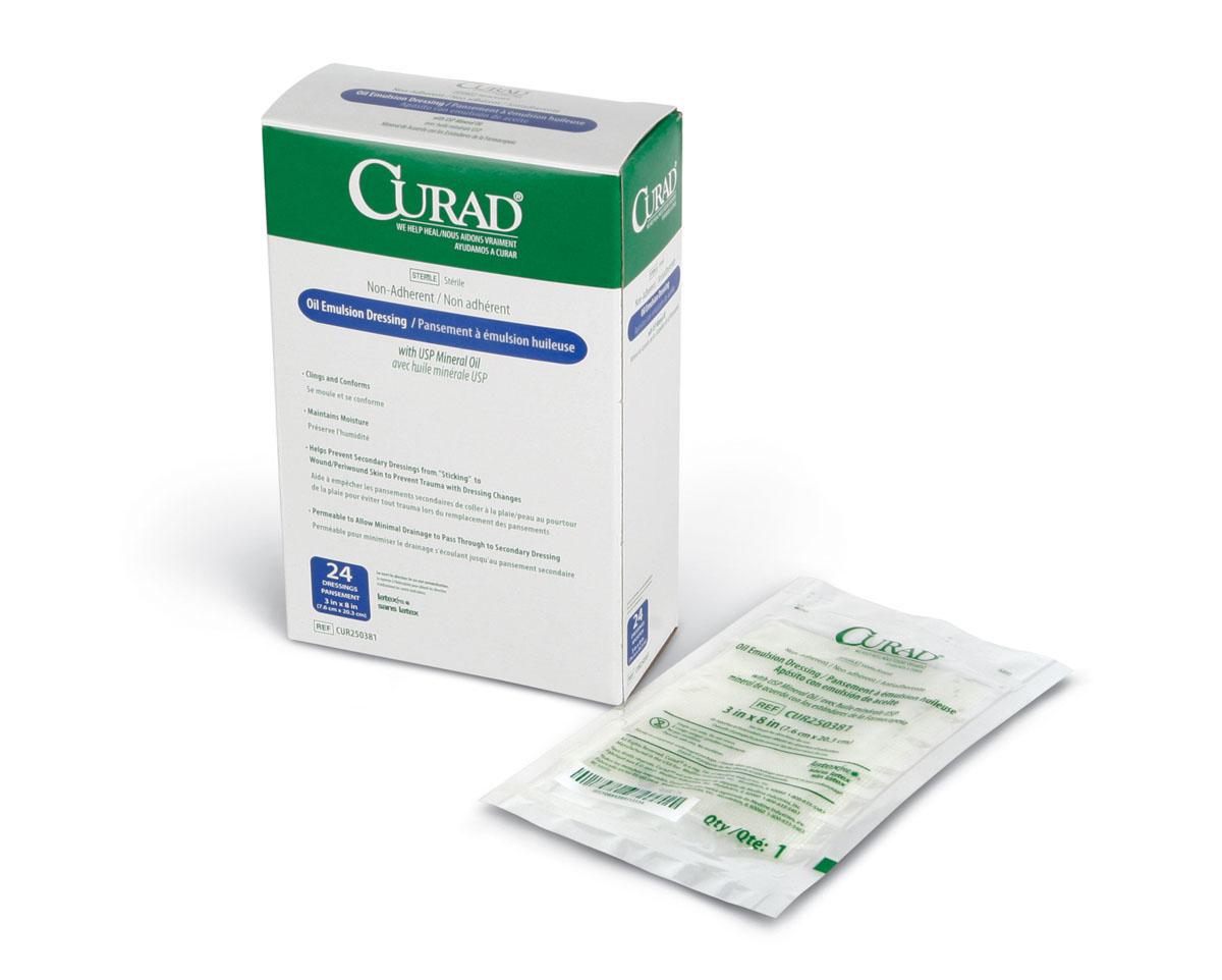 Curad oil emulsion non-adherent wound dressing box of 24 with one individually wrapped sterile dressing packet beside it