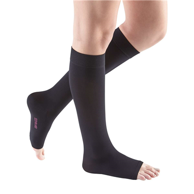 Compression stockings in black, knee-high open-toe style worn on both legs, shown from knees down