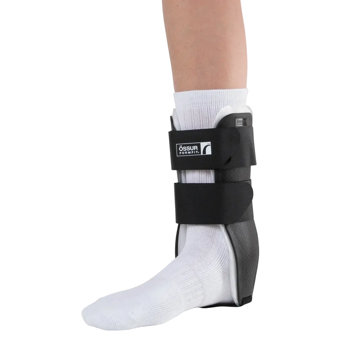 Ankle stirrup brace with air bladders and two black hook-and-loop straps worn over a white sock on a bare leg