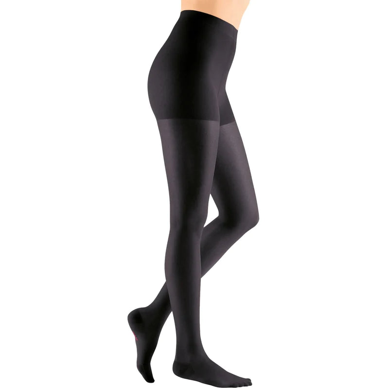 Compression pantyhose in black with closed toe and non-adjustable waistband, shown on a female model from waist to feet