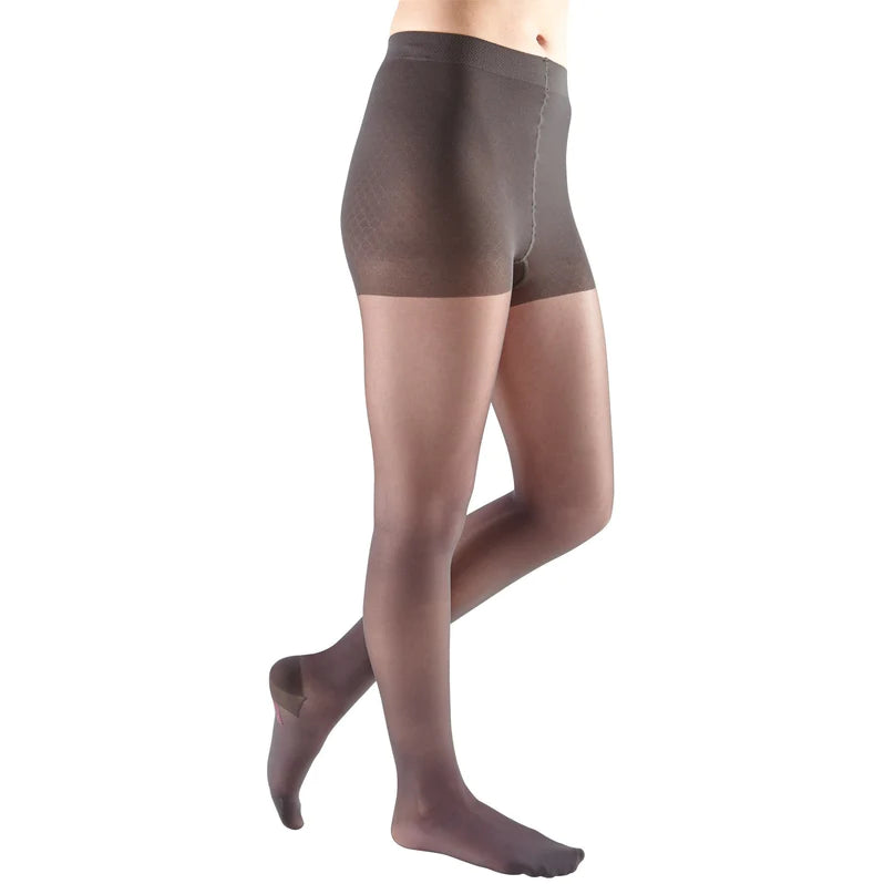 Compression pantyhose in sheer dark brown with a control-top waistband, shown on a female model from the waist down