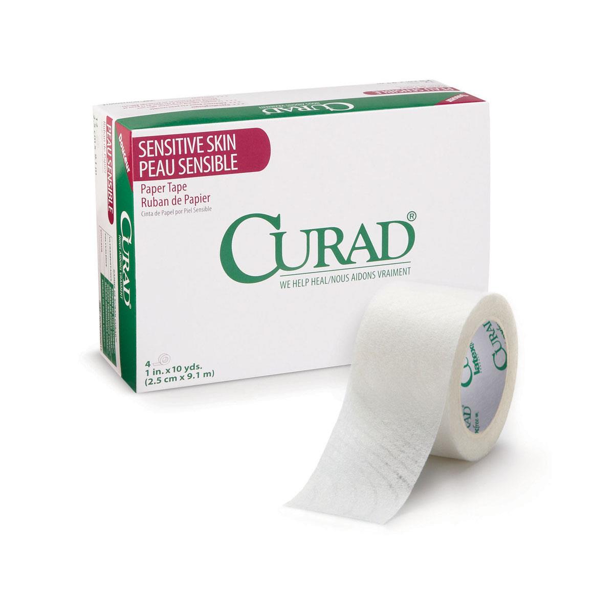 Medical paper tape roll beside a Curad Sensitive Skin Paper Tape box with green and pink branding on white background