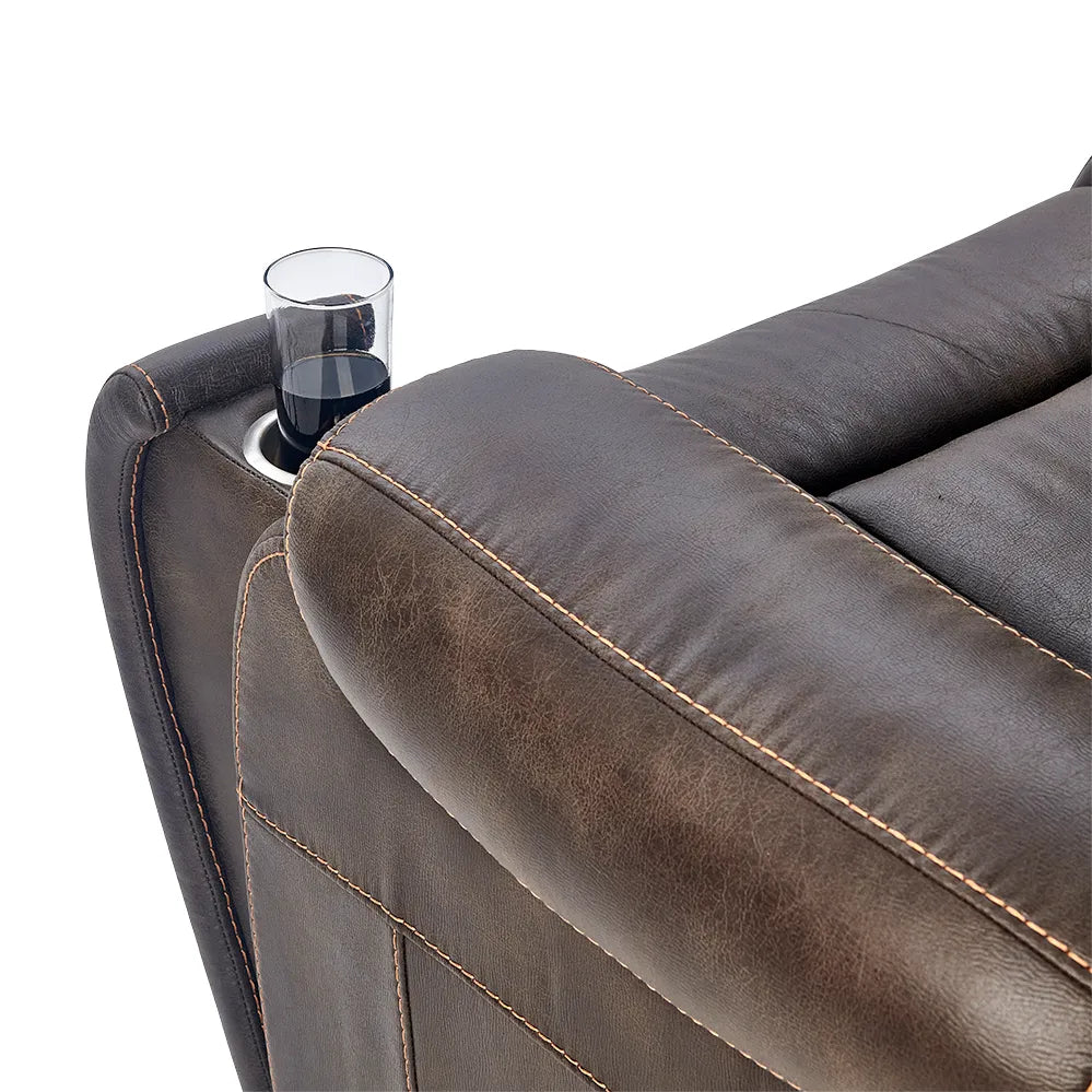 Lift chair armrest closeup showing built-in cup holder with glass, brown two-tone upholstery with contrast stitching