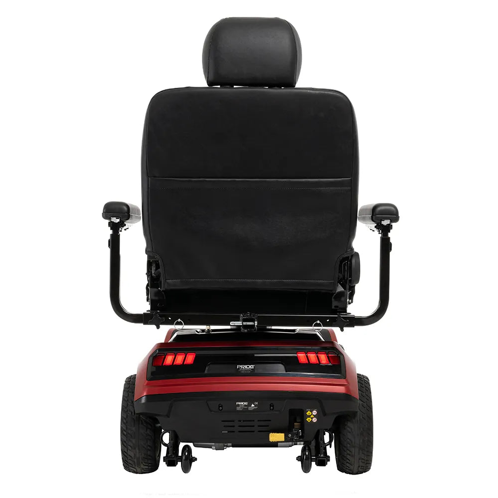 Power wheelchair rear view showing black high-back captain seat with headrest, padded armrests, and red base with rear