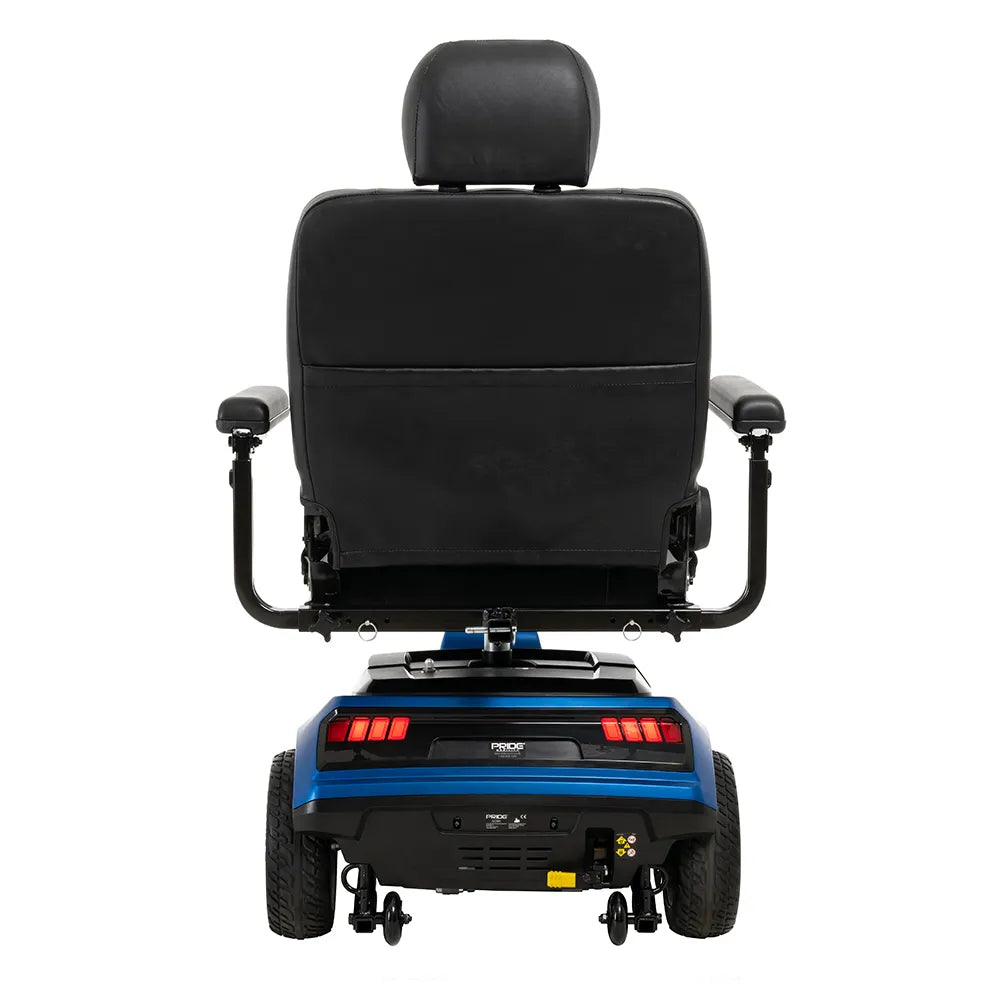 Power wheelchair rear view showing black padded captain seat with headrest, armrests, and blue base with red tail lights