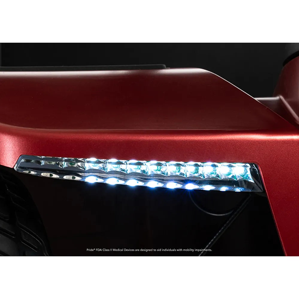 Power scooter front LED light bar glowing white on red metallic body panel, close-up detail view