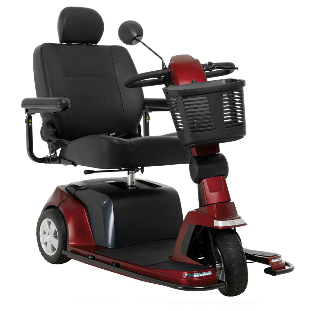 Power mobility scooter in red and black with three wheels, padded captain's seat, armrests, front basket, and rearview mirror