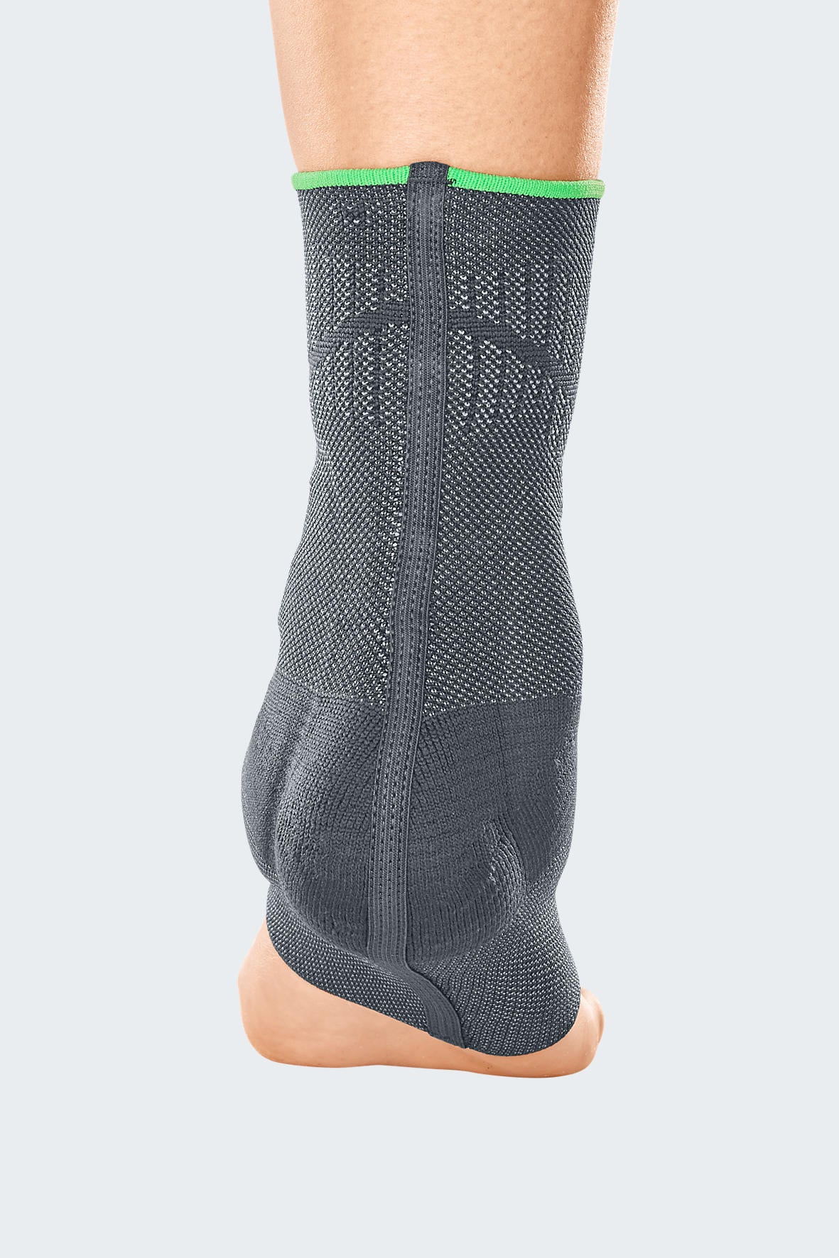 Ankle support in gray knit fabric with green trim at top, shown from rear on a bare foot and lower leg