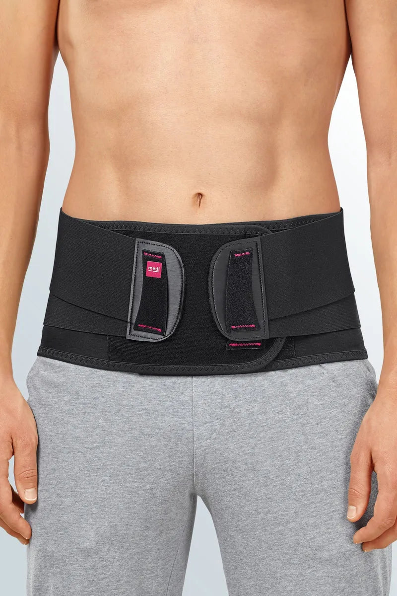 Back support brace worn around the lower torso, black neoprene with dual hook-and-loop closure panels and pink accent