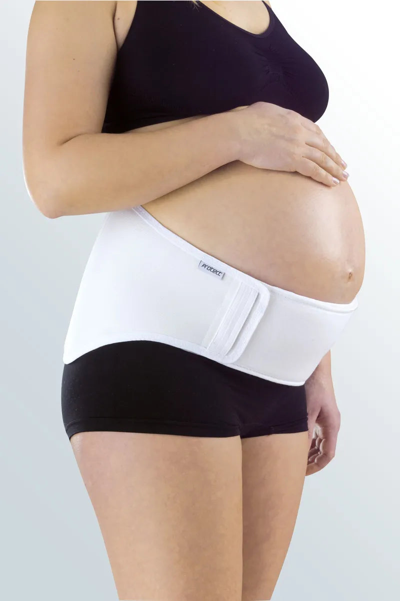 Protect Maternity Belt in white worn by a pregnant woman over black shorts, shown from the side
