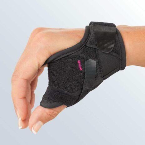 Rhizomed Soft Thumb Support black neoprene brace with hook-and-loop straps worn on a right hand and wrist