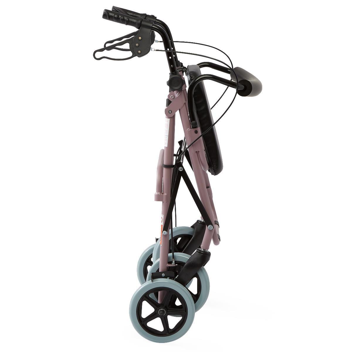 Rollator walker folded flat, side view, showing gray wheels, hand brakes, and padded seat, with a mauve pink frame