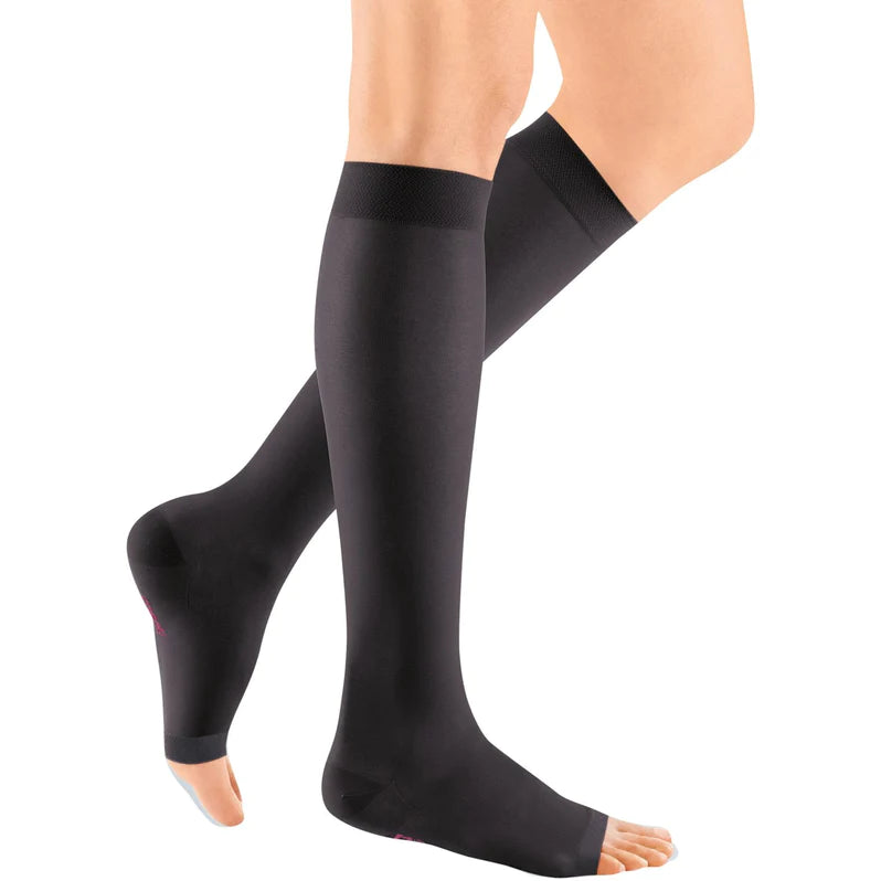 Compression stockings in black, knee-high open-toe style worn on a person's legs, shown from two angles