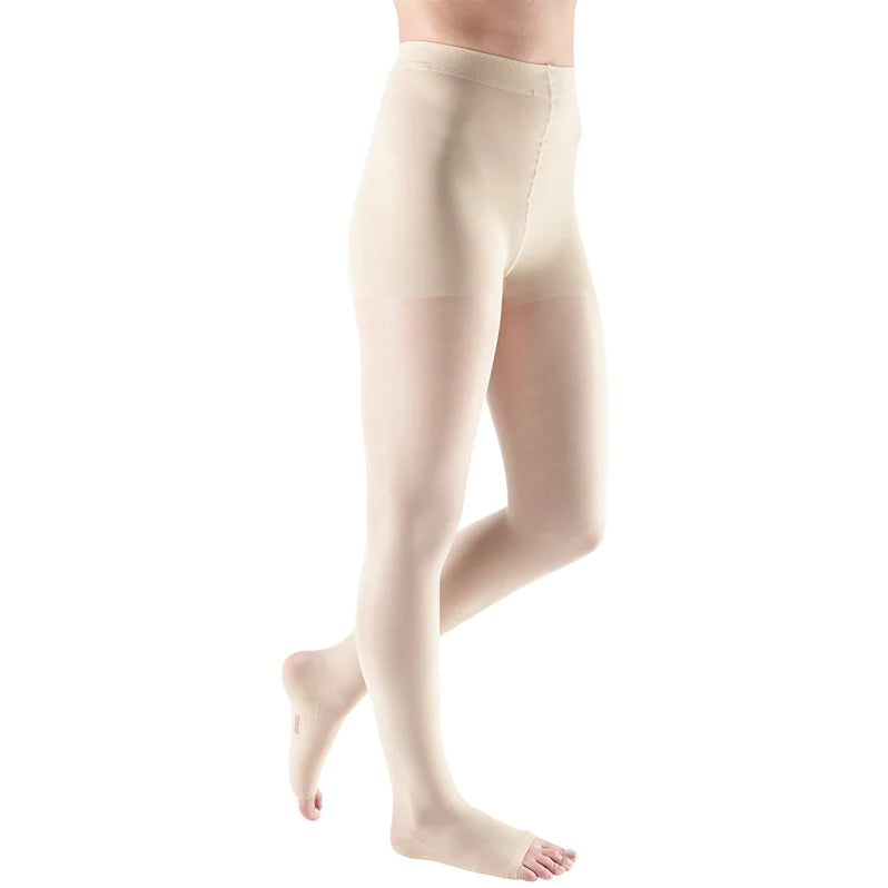 Compression pantyhose in beige with open toe and non-adjustable waistband, shown on a person from waist down