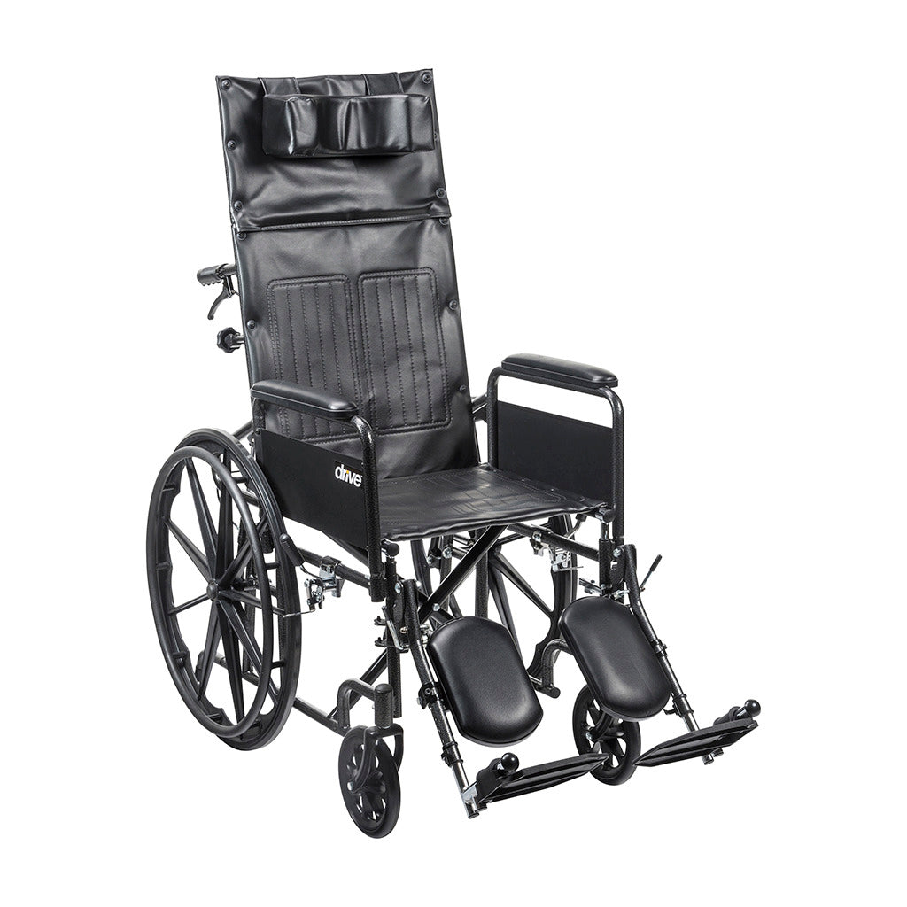 Reclining wheelchair with tall padded back, headrest, padded armrests, elevating leg rests, and black steel frame on white